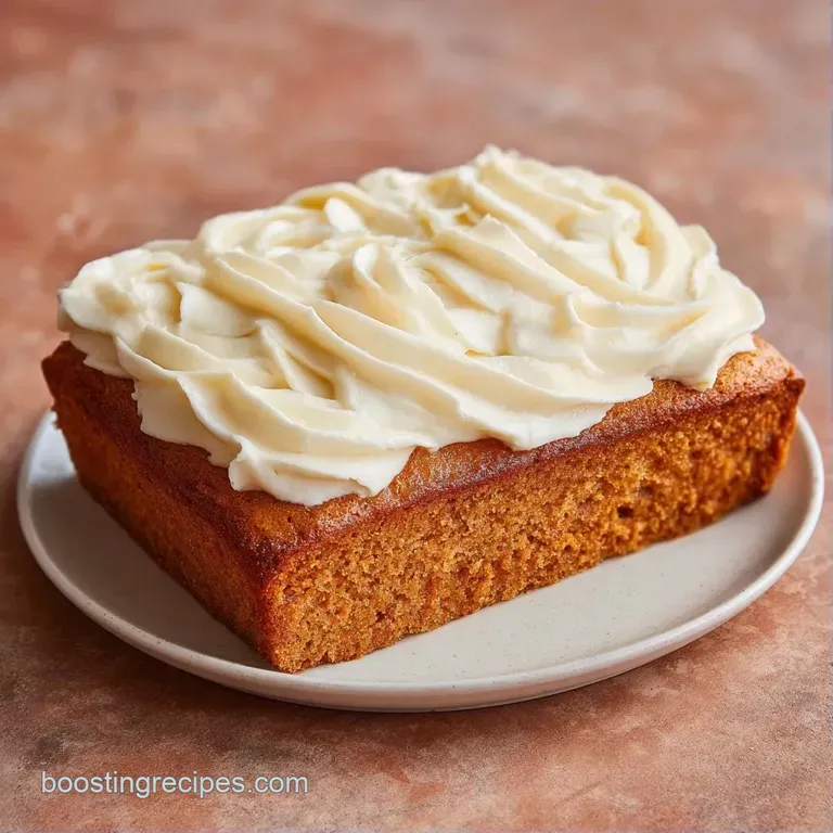 A fluffy slice of golden cake with a thick, creamy white frosting layer served on a minimalist white dessert plate.